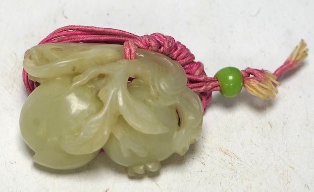 A 19th century jade carving of fruit, 5.5cm wide. Condition - fair, a small piece missing